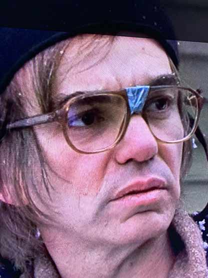 Billy bob thornton wearing self repaired glasses by taping the center.
